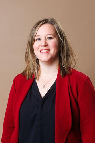 Amanda Seidenzahl wears a red blazer and black shirt during a professional photo shoot